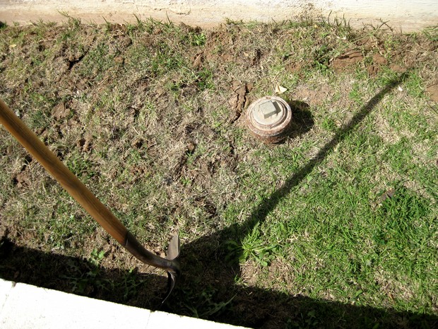 cutting grass mat with shovel blade half done