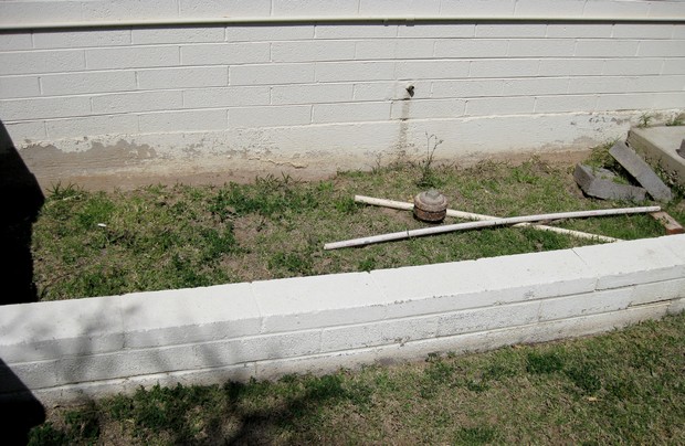 old flower bed with junk